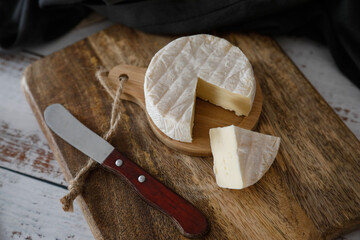 Delicious brie cheese on a wooden background