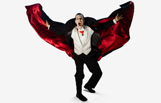 Themed portrait of a vampire on a white background lunging towards camera with cape flying out behind him, fangs out and mouth open