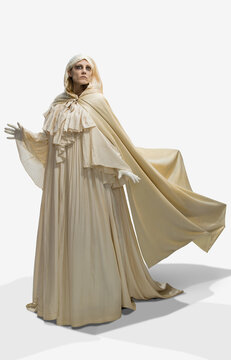 Woman dressed as a ghost in Halloween costume gliding and hovering in frame against white background