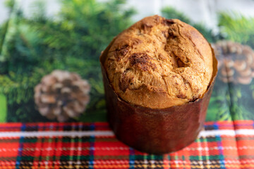 Italian Panettone on a table with a tablecloth decorated for Christmas, in close-up photo and top view