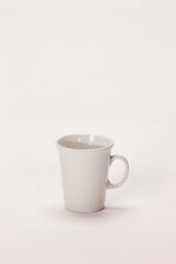 Still life of a white coffee mug on white background. 