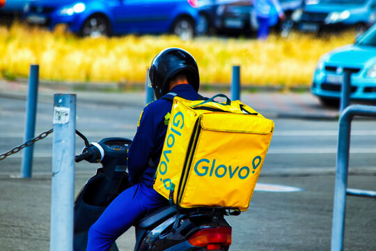 Kiev, Ukraine - July 08, 2020. The scooter courier with Glovo backpack,  Glovo is a Spanish on-demand courier service Stock Photo | Adobe Stock