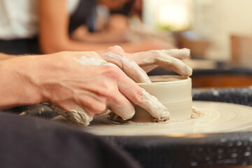Fototapeta na wymiar Woman's hands making pottery