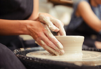 potter, clay, workshop, Woman's hands making pottery circle - obrazy, fototapety, plakaty