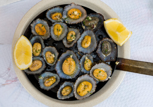 tasty seafood - grilled limpets served with lemon.
