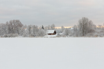 old wooden house abandoned in winter landscape