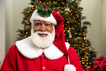 Portrait of Black Santa Claus smiling into camera.