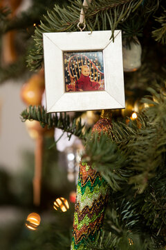 Picture frame Christmas decoration on tree with baby. 