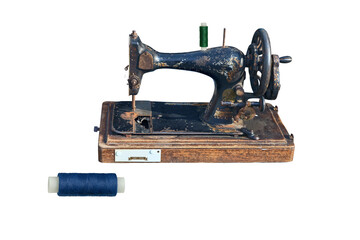 old sewing machine and spool of thread on a white background