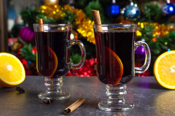 two glasses with hot mulled wine orange and cinnamon