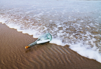 Message in a glass bottle washed up on the shore