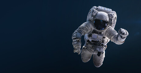 Astronaut floating and isolated on dark background. Spaceman sci-fi space wallpaper. Elements of...