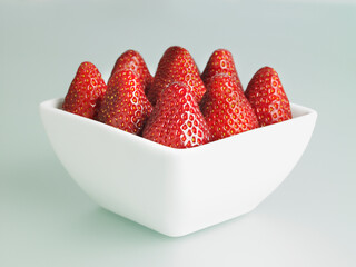 Strawberries in a square white bowl