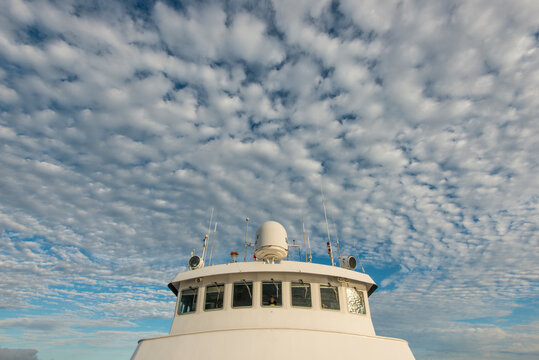 View of the bridge of the National Geographic Sea Lion after sunrise with interesting clouds and blue sky in Baja California Sur
