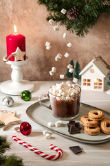 Christmas homemade hot chocolate drink with white mini marshmallow sweets floating in the air. Image of levitation