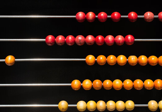 Beads on wooden rainbow abacus for number calculation. Mathematics learning concept
