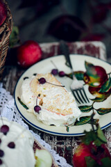 Biscuit roll with apples and whipped cream.Dark rustic photo