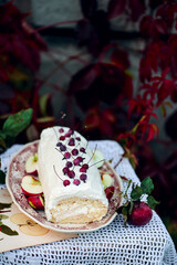 Biscuit roll with apples and whipped cream.Dark rustic photo