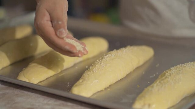 Detail shot of hand sprinkling bolillo decoration 