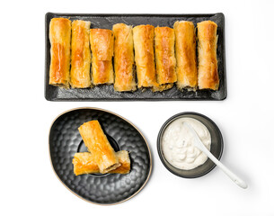 Meat rolls pastry - fried minced pork meat in spring rolls in a serving plate with a bowl of tartar sauce, isolated on white background with clipping path included. Top View