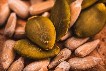 Macro View of Sunflower and Pumpkin Seeds on the Wooden Board.