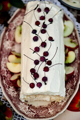 Biscuit roll with apples and whipped cream.Dark rustic photo