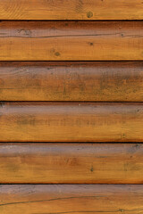 Log back. Rough wood texture. The walls of a country house are made of rough logs or boards.