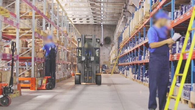 People work in a warehouse. Active work in the warehouse. Factory warehouse workflow