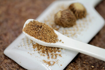Nutmeg grated on the porcelain grater