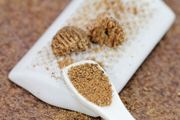 Nutmeg grated on the porcelain grater