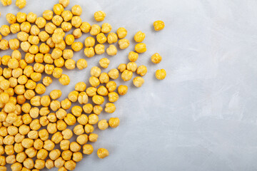 Fried chickpeas scattered on gray textured surface of the table. Top view, copy space. Leblebi, Turkish snack