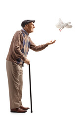 Full length profile shot of an elderly man with a white dove