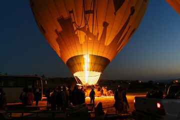 Cappadocia, Turkey - 21 July 2021: Launching balloons, preparing for departure and receiving tourists on board. Early morning balloon inflation