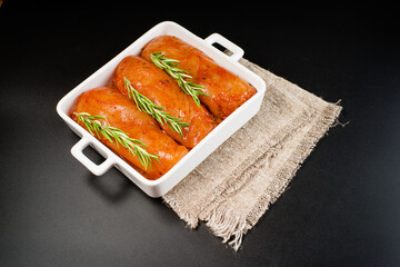 Diet meat.Raw marinated chicken fillet in red sauce in a roasting plate Fresh marinated chicken for roasting.