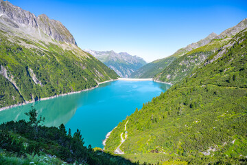 Fototapeta na wymiar Beautiful alpine walley with azure blue water dam