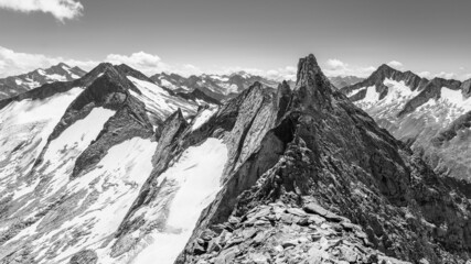 Pointed rocky mountain ridge on sunny summer day