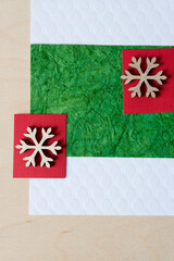 wooden snowflakes on red paper squares