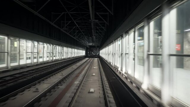 Moving unmanned subway - automatic metro station in Paris. Riding underground train in modern city. Footage of modern public mode of transport