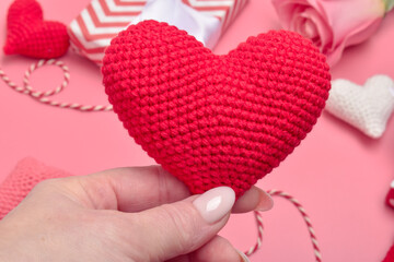 Fototapeta premium A red heart is in women's hands. Banner, Valentine's Day card.