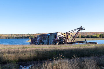 Fototapeta na wymiar The famous Quincy Dredge Number Two sits abandoned in a marsh on the Keweenaw Peninsula