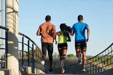 Mixed group of anonymous black athletes running away 
