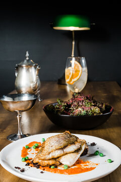 Pan fried fish with antique tableware