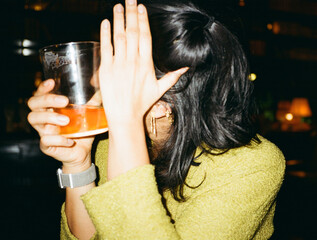 woman blocking face from camera