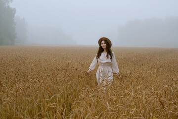 asian girl posing in wheat field in beige dress