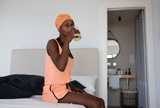 African woman enjoying lemon water
