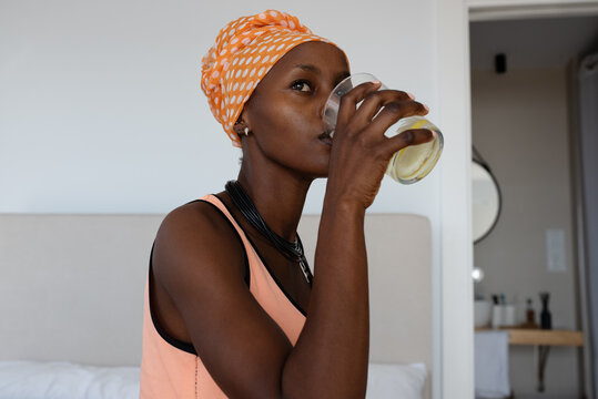African woman sipping water in morning