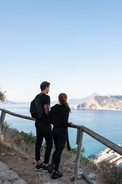 Couple admiring sea water from cliff