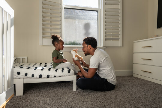 A dad sits with daughter