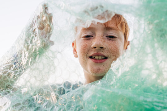 Child wrapped in bubble wrap