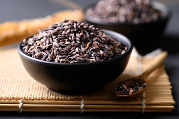 Thai purple glutinous rice grain in black bowl, Organic and healthy food